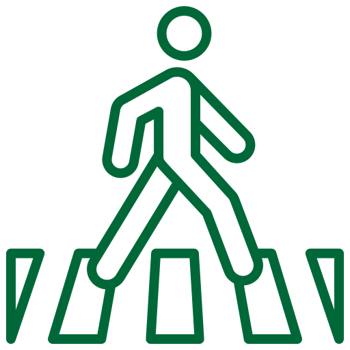 A green line icon of a pedestrian crossing sign and a individual crossing the street.